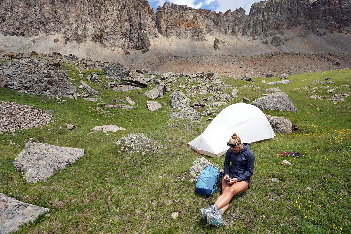 Person sitting outside tent in mountains (Big Agnes Fly Creek HV UL2 Solution Dye)
